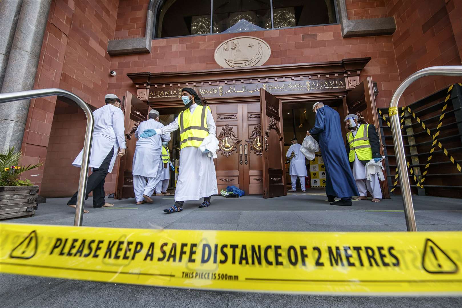 Worshippers observe social distancing as they arrive at the Bradford Grand Mosque (Danny Lawson/PA)