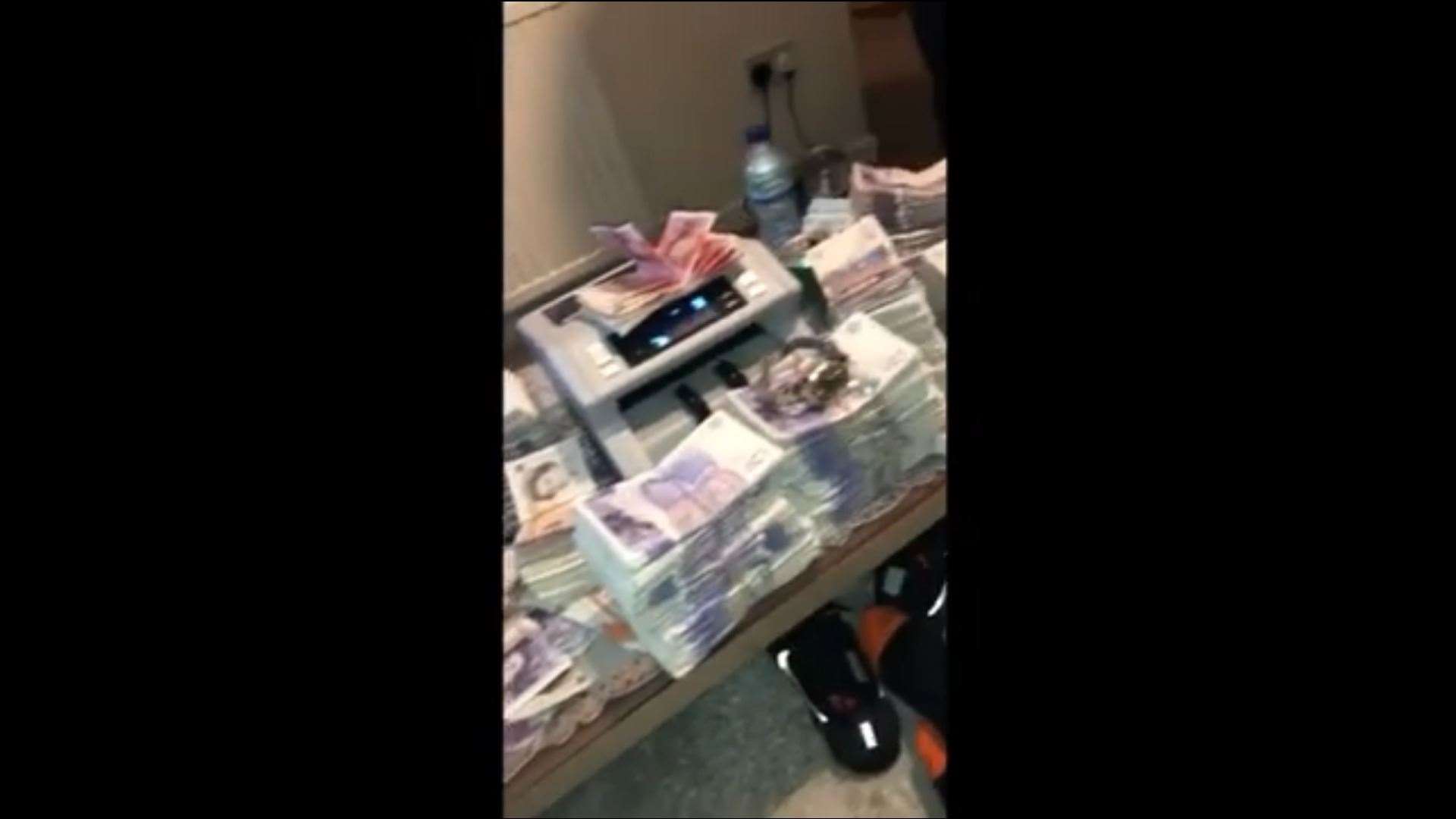 Money and a Rolex can be seen during the video (12213979)