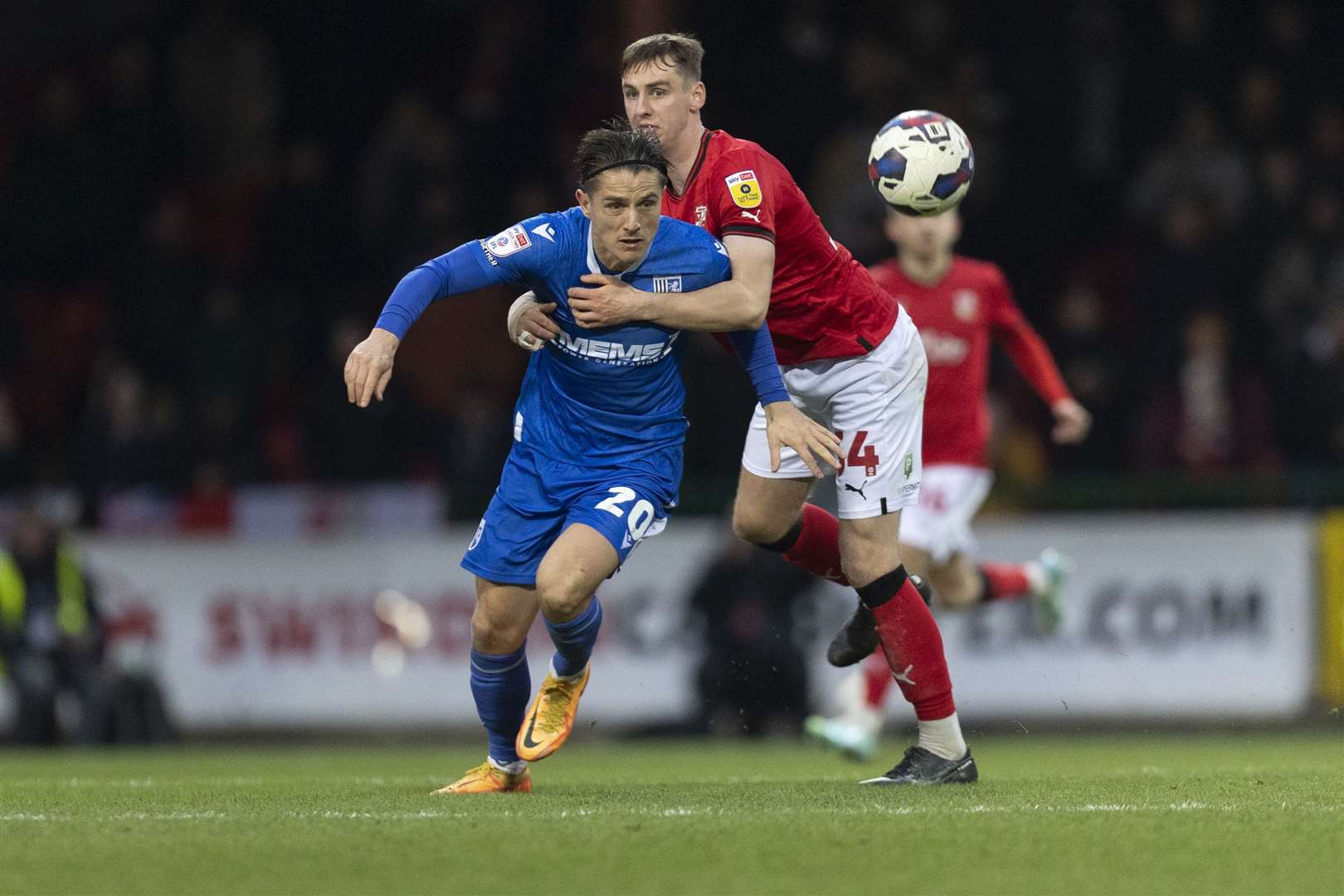 Gillingham striker Tom Nichols being held back against Swindon