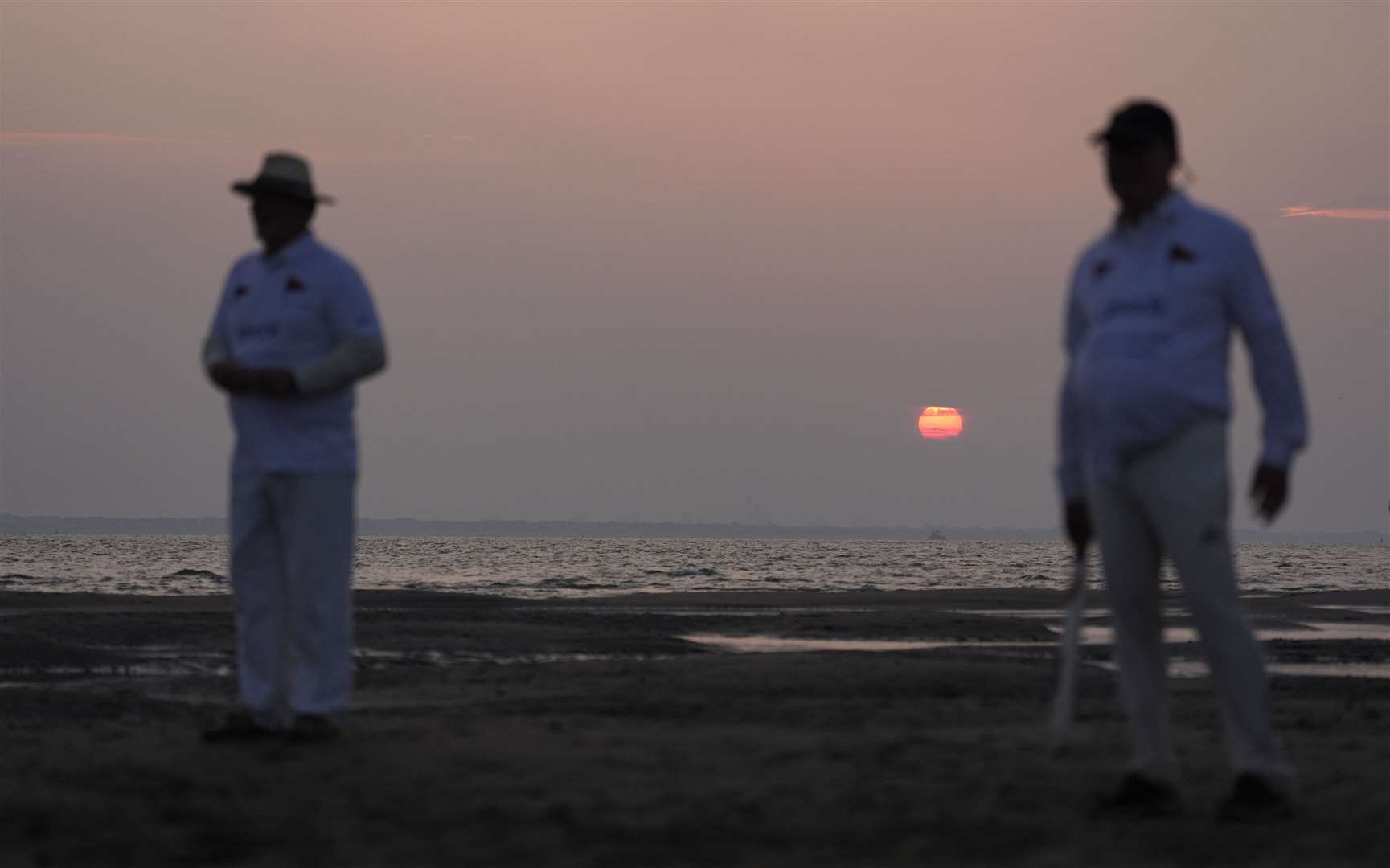 The sun begins to rise as members of the Royal Southern Yacht Club and the Island Sailing Club take part in the annual Brambles cricket match (Andrew Matthews/PA)