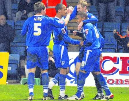 From left: Simon King, Curtis Weston and Gary Mulligan celebrate the equaliser with scorer Simeon Jackson. Picture: Grant Falvey