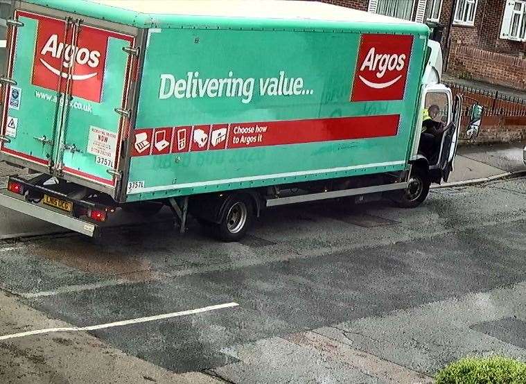 The driver of the Argos lorry looks back at the damaged car, having pulled over on the other side of the road (14839064)