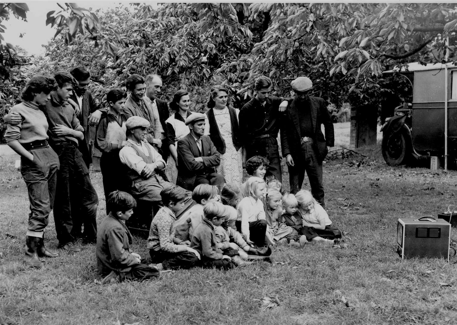 A portable TV, run by a 12-volt battery, provided entertainment for fruit pickers at Selling in July 1956