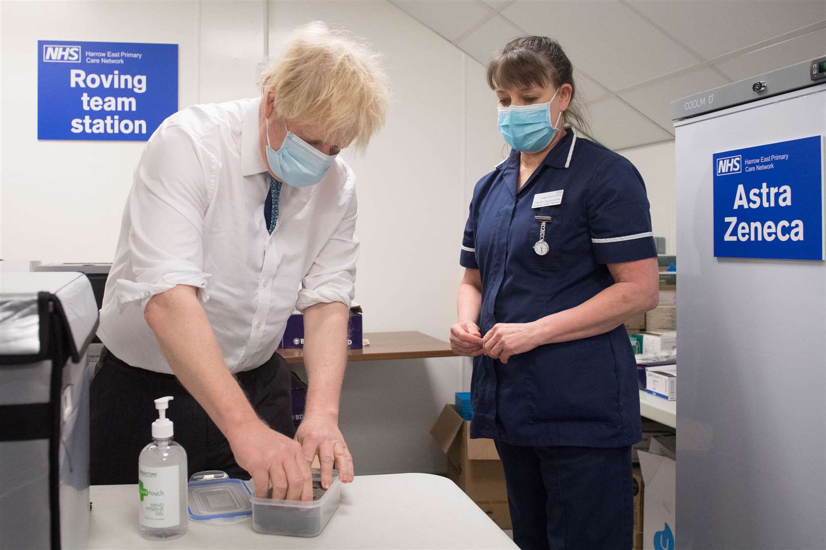 Mr Johnson sees how a dose of the Oxford/AstraZeneca Covid-19 vaccine is prepared, with nurse, Tracey Wilkinson (Stefan Rousseau/PA)