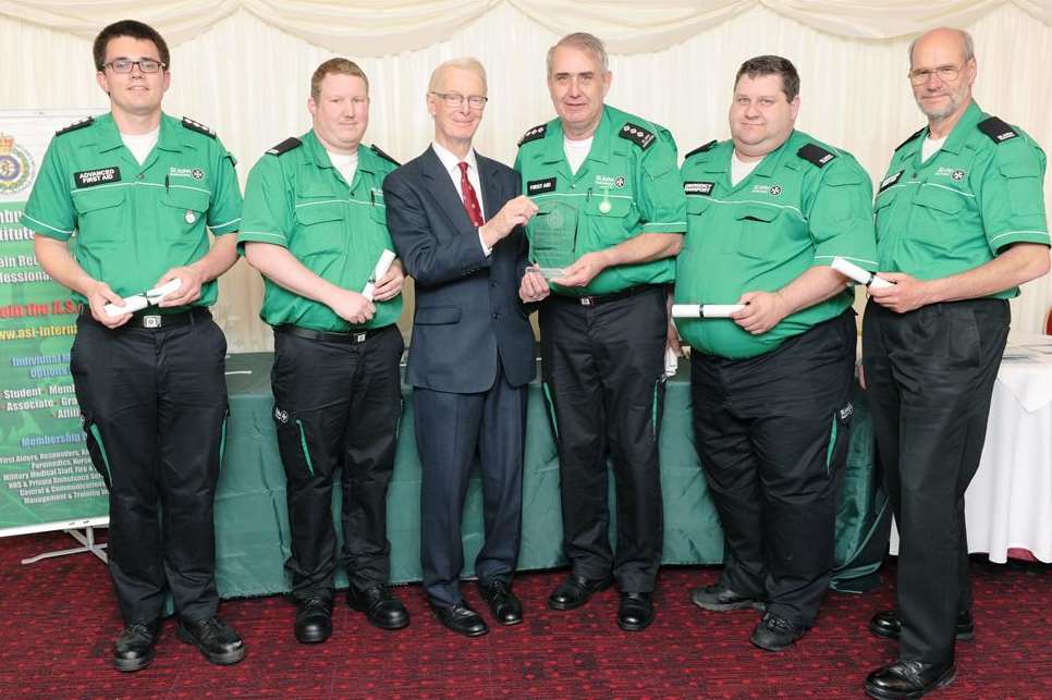 The Lord McColl of Dulwich CBE presenting Philip Le Masonry and other St John Ambulance team members with their award. Picture: Simon Hildrew and ASI.
