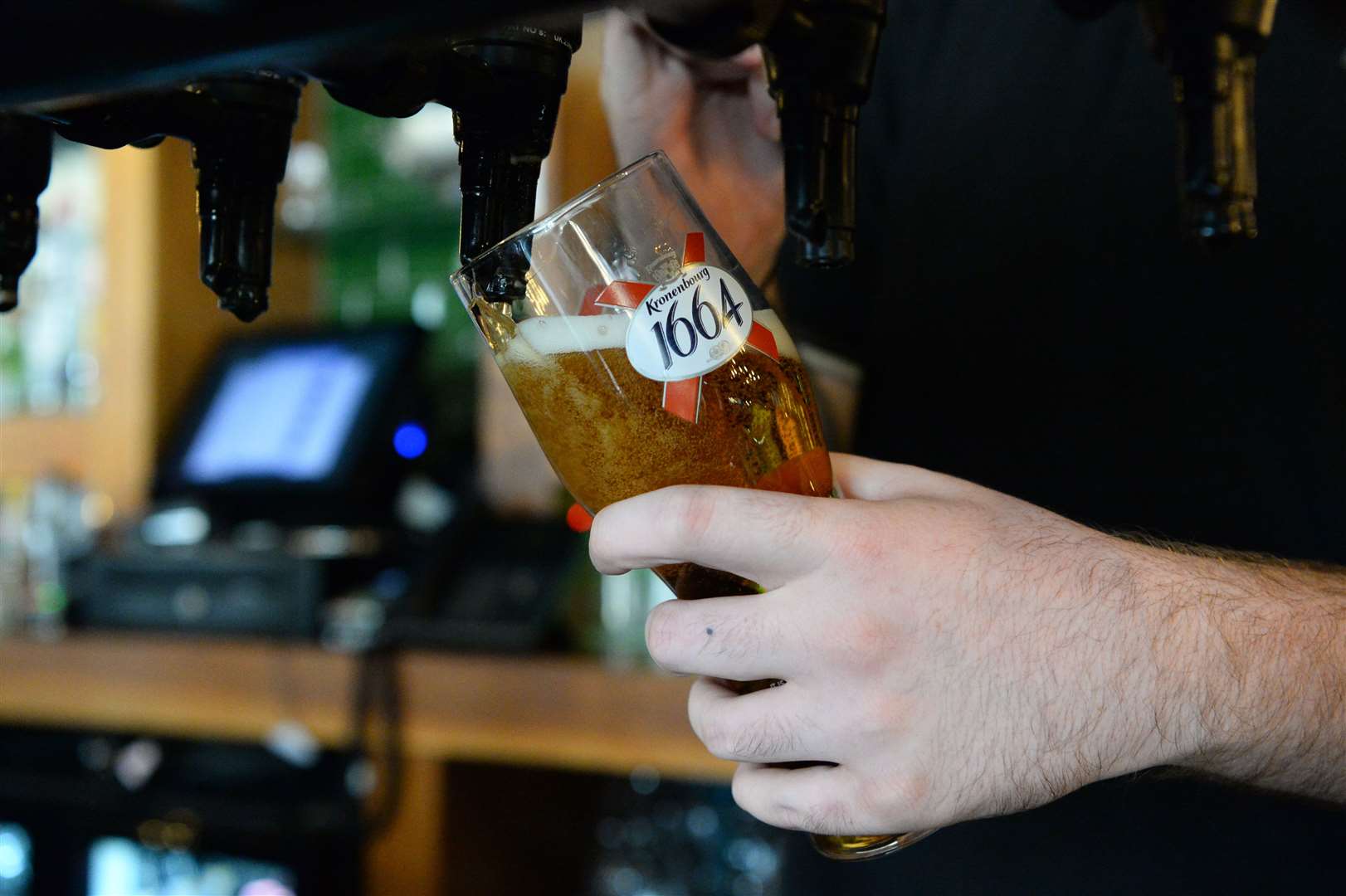 A bar tender pouring a Kronenbourg beer in a pub in Fulham, London (Kirsty O’Connor/PA)