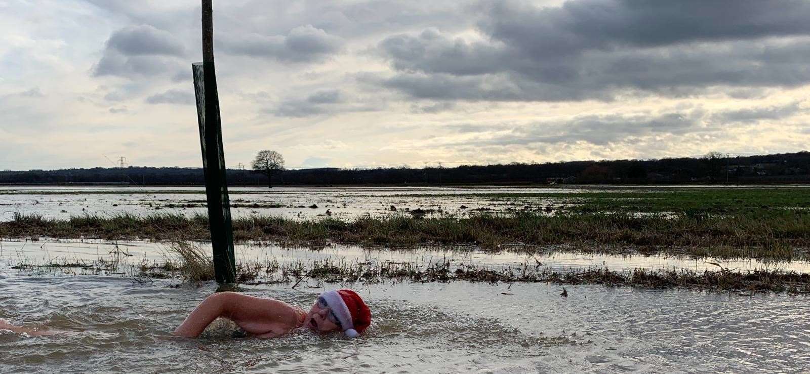 Jackie Cobell, a Capel resident, swam in flood water on Hartlake Road to highlight the flood risk