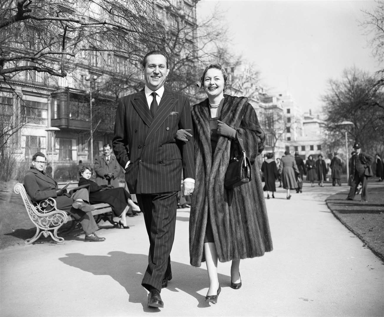 De Havilland, 39, and her magazine director fiance Pierre Galante stroll along Victoria Embankment Gardens in London (PA)