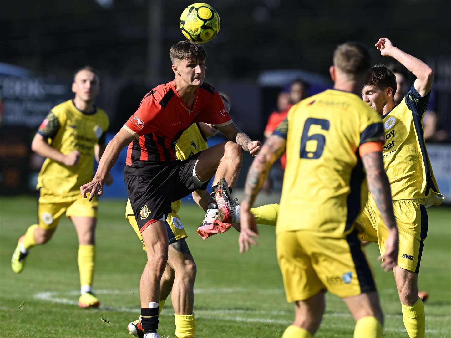 Sittingbourne (red) get ahead of Plymouth Parkway during their FA Cup clash on Sunday. Picture: Barry Goodwin