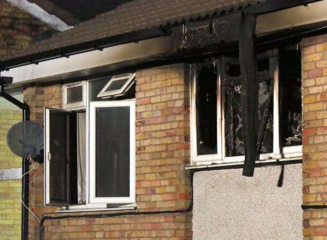 The damaged flat with blackened out windows. Picture: UKNip (30014884)