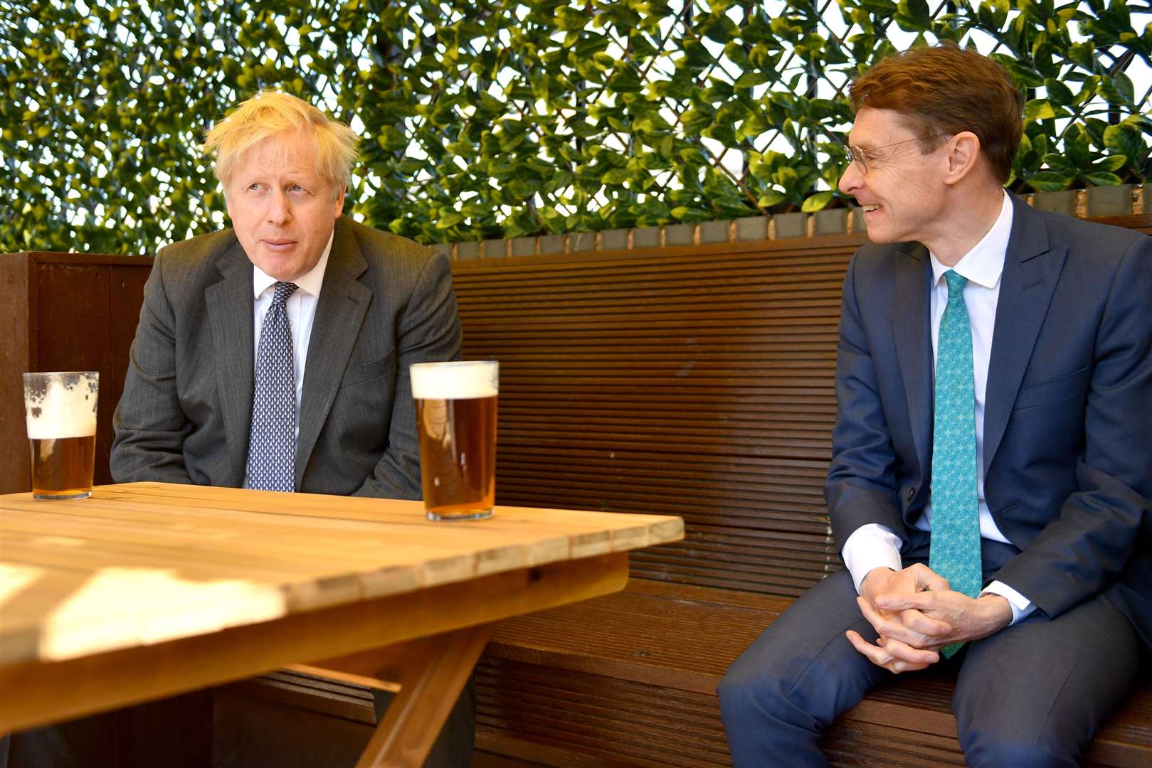 Prime Minister Boris Johnson sips a pint in the beer garden with West Midlands Mayor Andy Street during a campaign visit (Jacob King/PA)