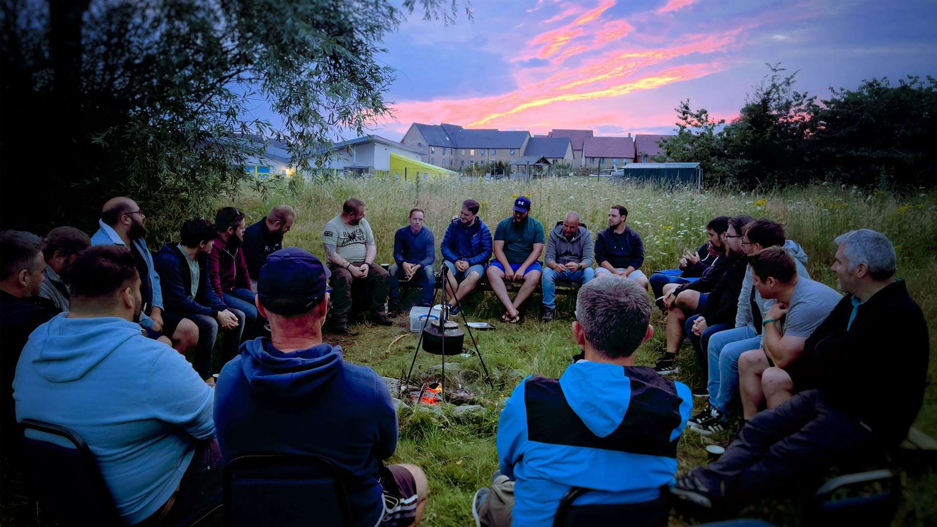 Dads get together for a DadSpace session around a campfire