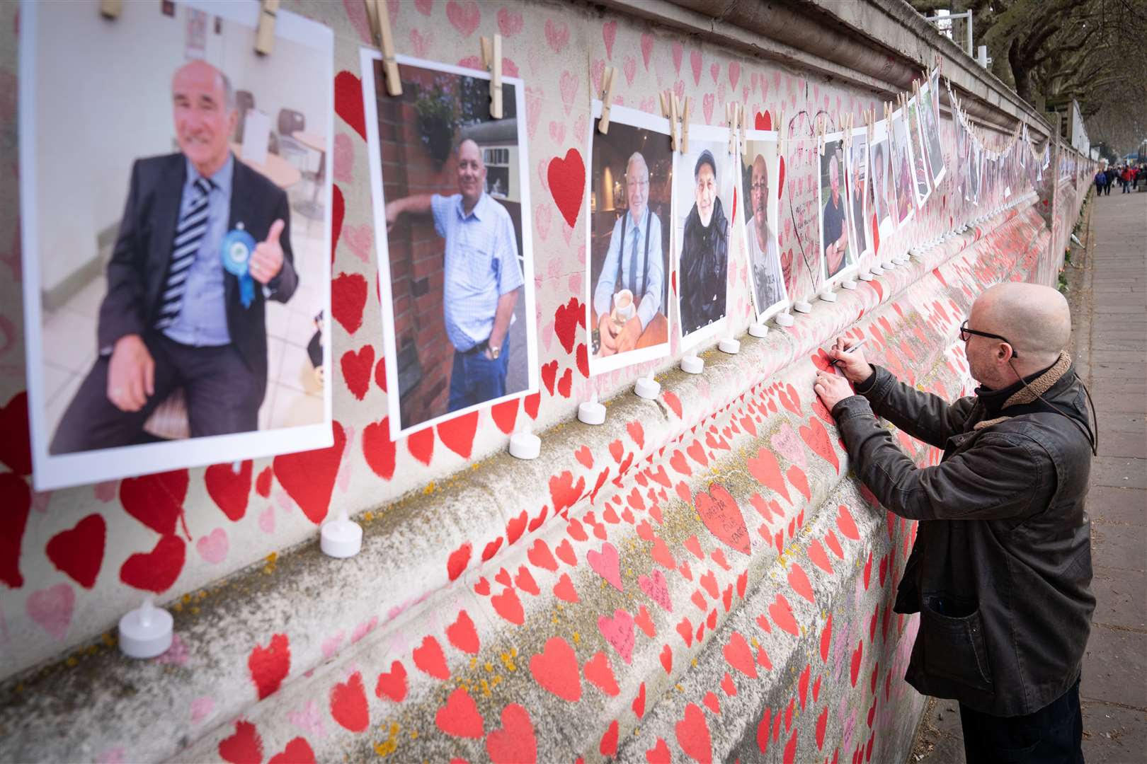 A family member pays their respects (Stefan Rousseau/PA)