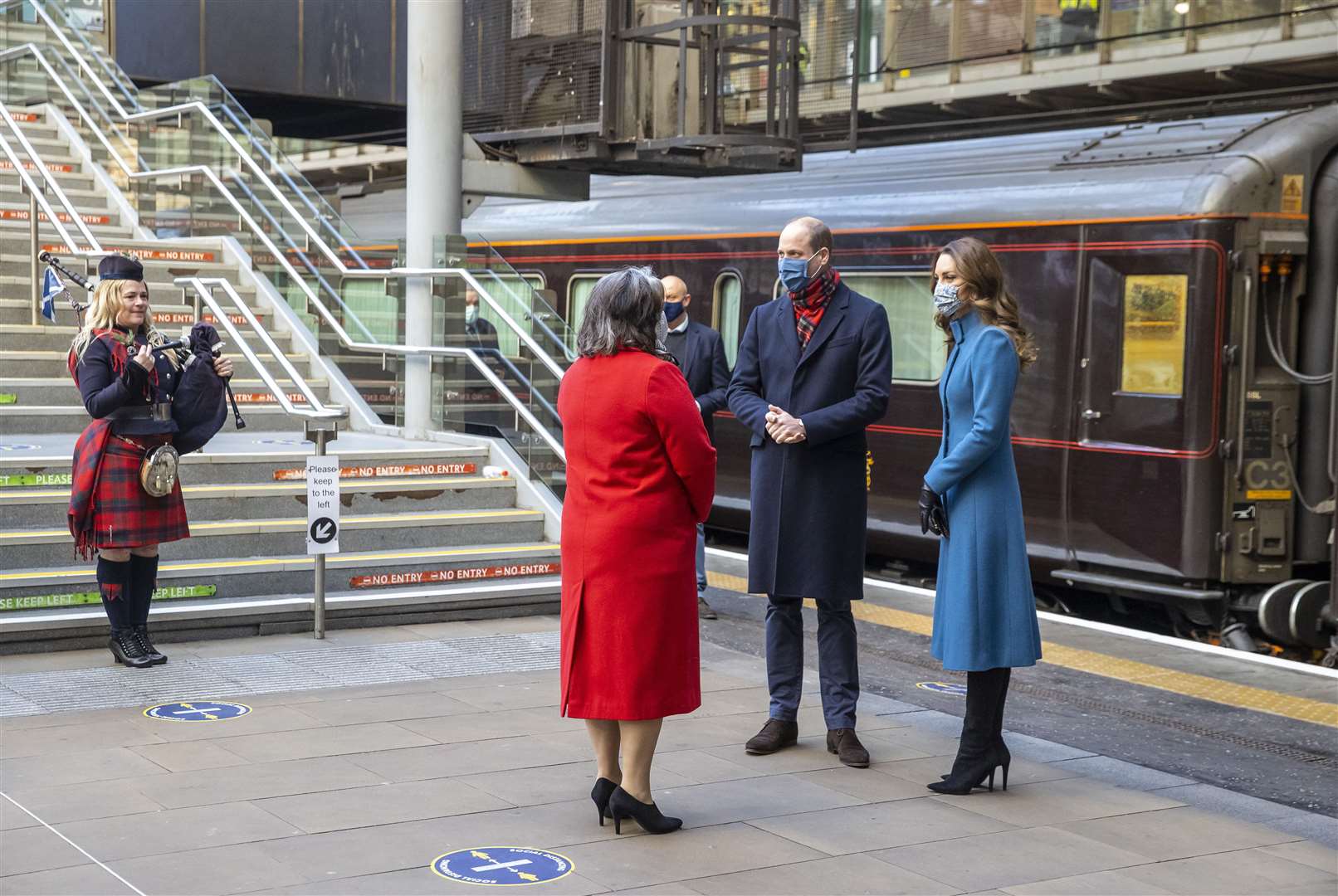 The Duke and Duchess of Cambridge are met by Deputy Lord Lieutenant Sandra Cumming and piper Louise Marshall as they arrive by train at Edinburgh Waverley Station (Andy Barr/PA)