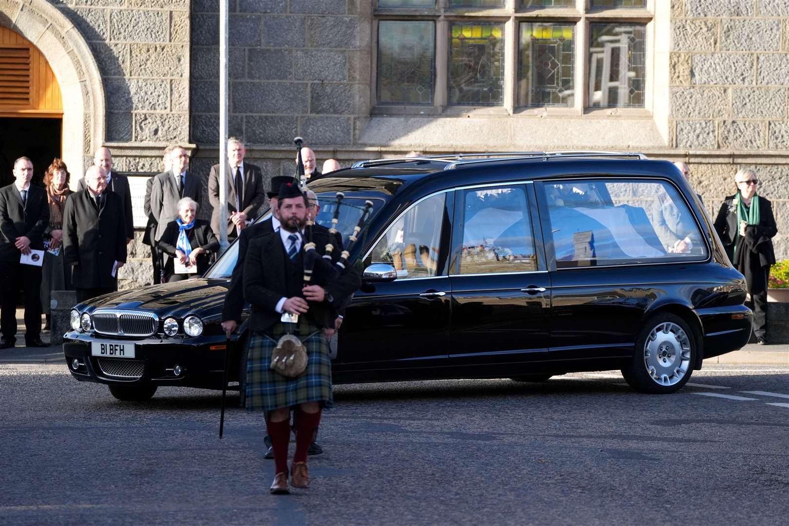 The funeral cortege was led by Fergus Mutch on bagpipes (Andrew Milligan/PA)