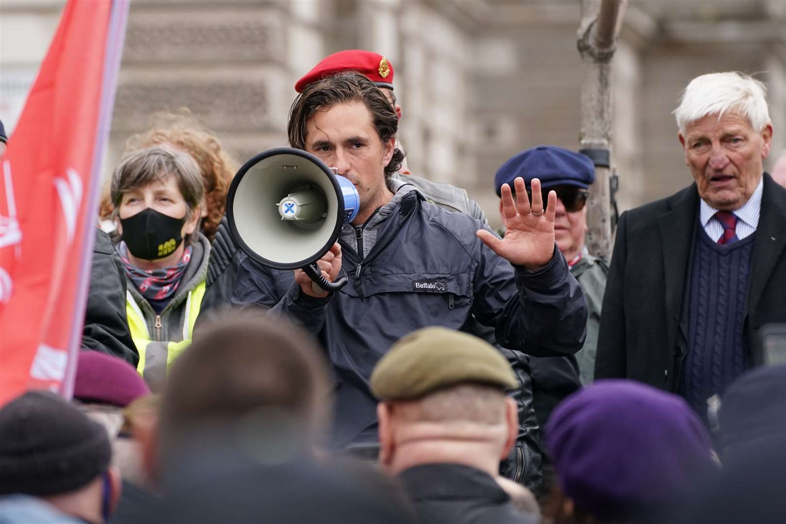 Former veterans minister Johnny Mercer, with Dennis Hutchings (right), as he addresses the veterans march in Parliament Square (Steve Parsons/PA)