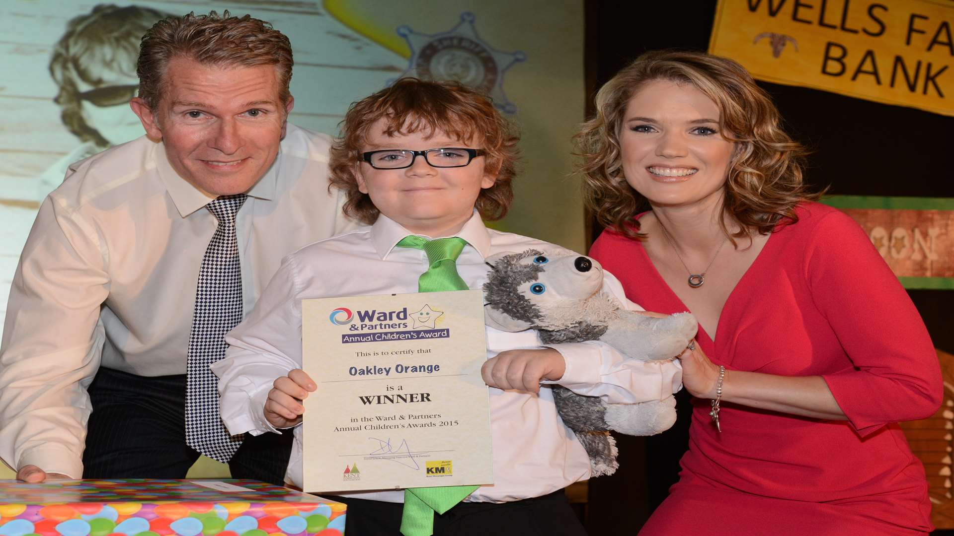 Lee Crane, regional managing director for Ward & Partners, and Charlotte Hawkins presenting an award to Oakley Orange