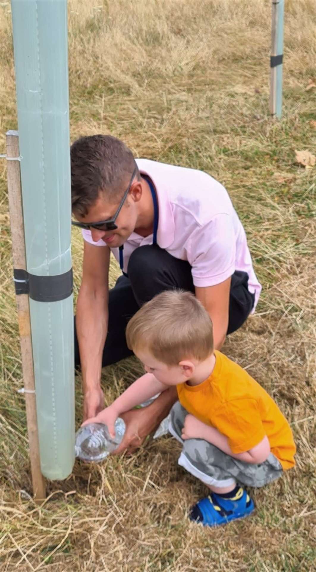 Cllr Martin Potter and a young assistant keeping the saplings watered. Image: Martin Potter