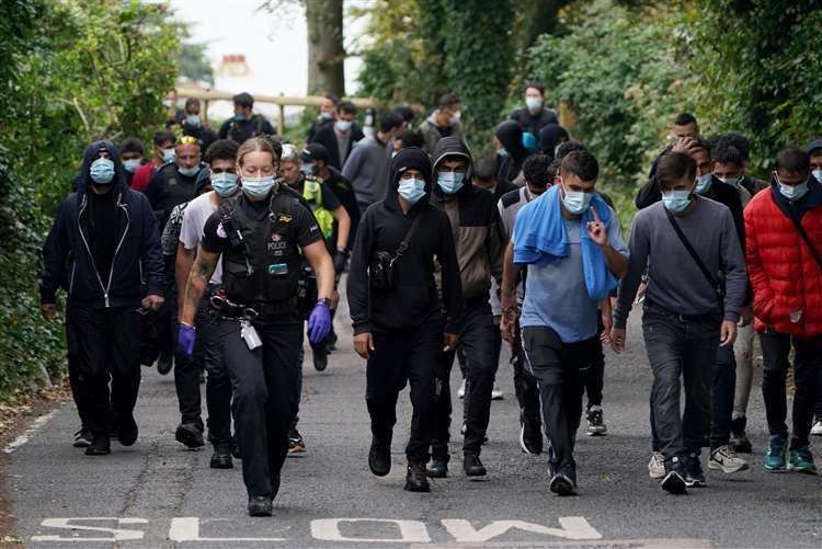 Ayslum seekers escorted by police and Border Force officers from St Margaret's Bay. Picture: Gareth Fuller/PA (61621429)