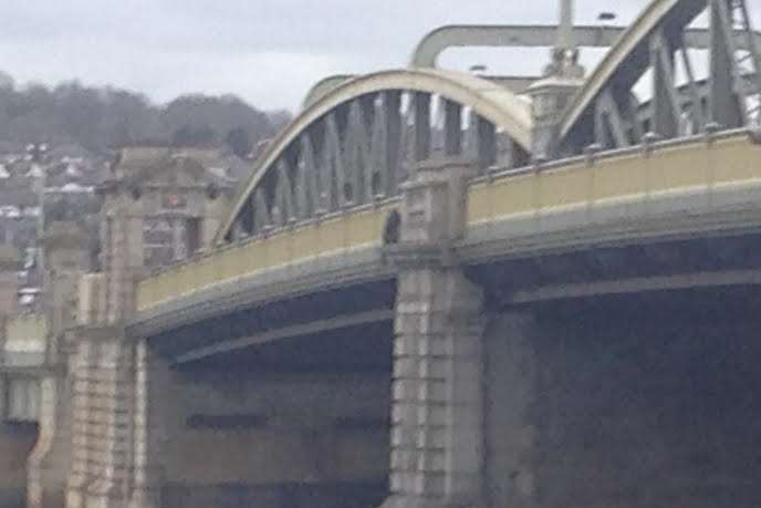 The man was on the wrong side of the railings of Rochester Bridge. Stock image