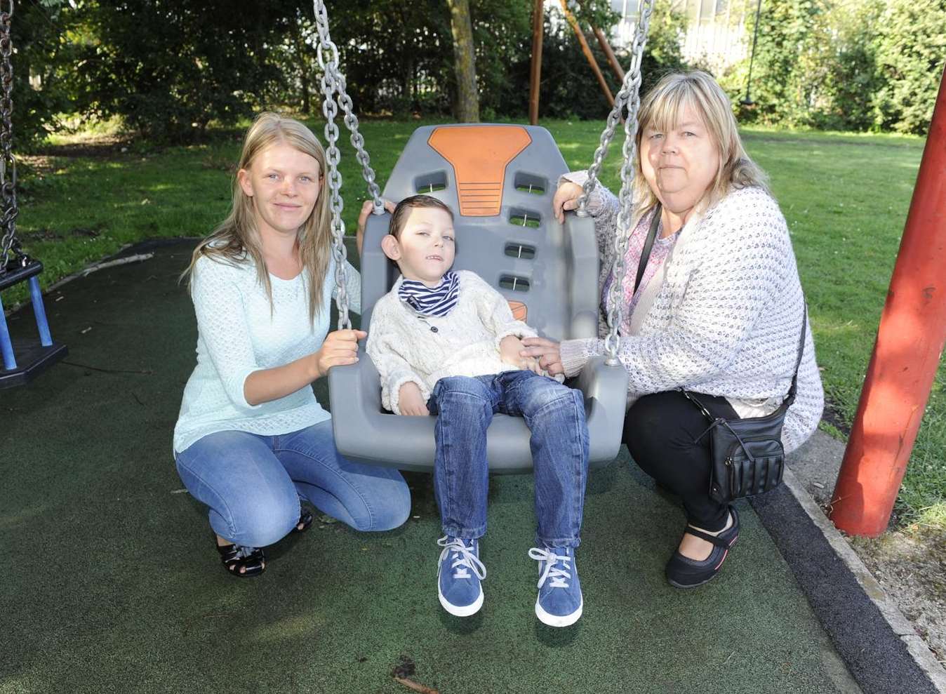 Six-year-old Sean Munday with mum Naomi (right) and Linda Munday, pictured when the swing was installed