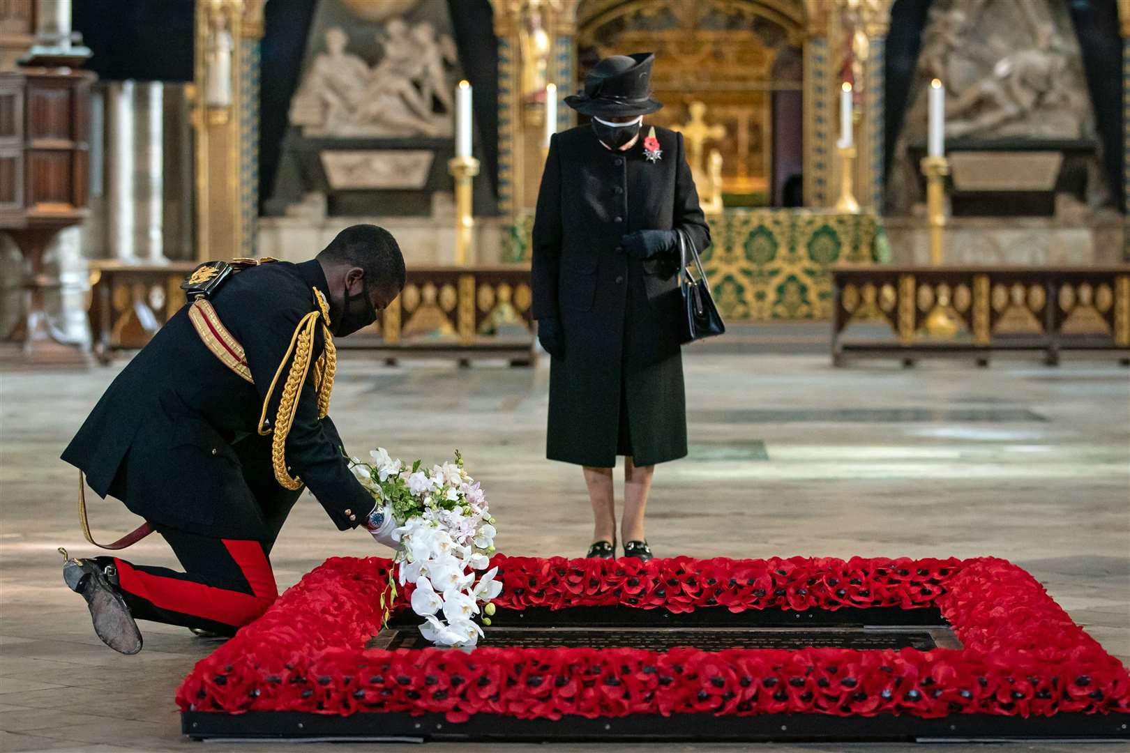 The late Queen’s Equerry places a bouquet of flowers at the Grave of the Unknown Warrior on her behalf in November 2020 during the pandemic (Aaron Chown/PA)