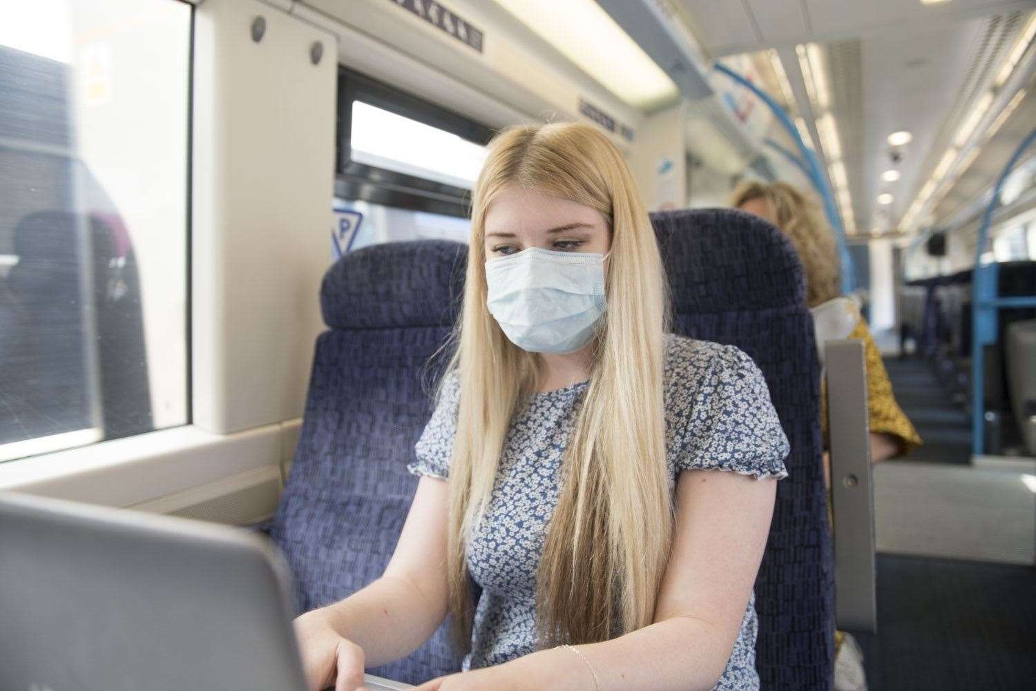 A Southeastern passenger wearing a face mask