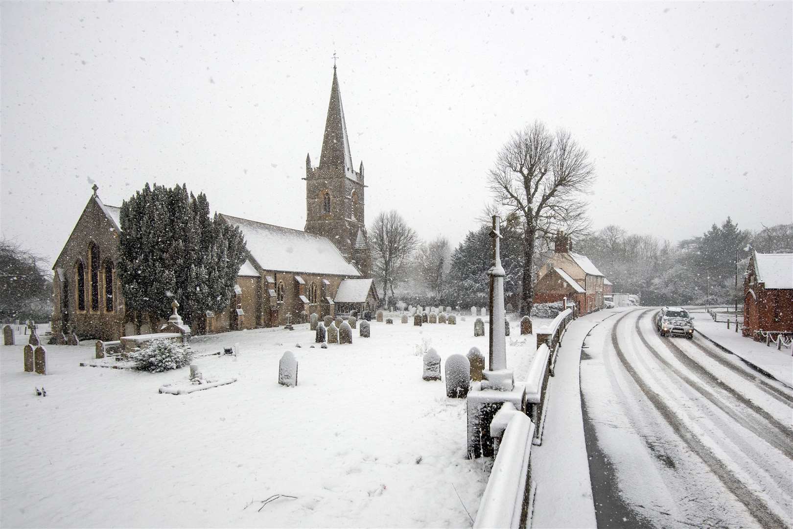 Snow falls around St Edmund King & Martyr Church in Tendring (Joe Giddens/PA)