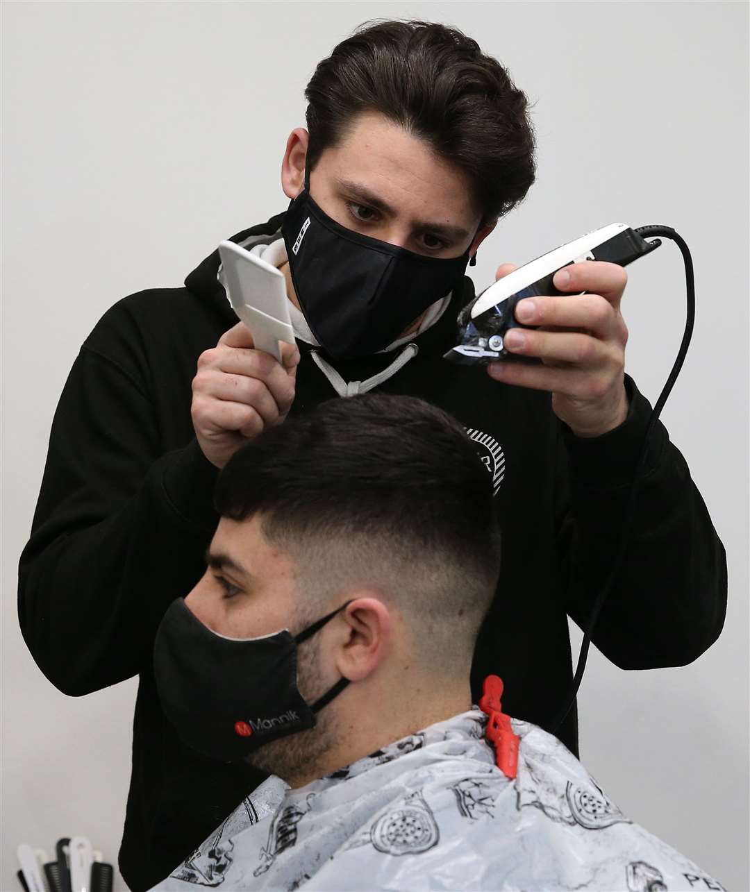 Barber Tony Mann’s first customer was his brother Maxx (Andrew Milligan/PA)