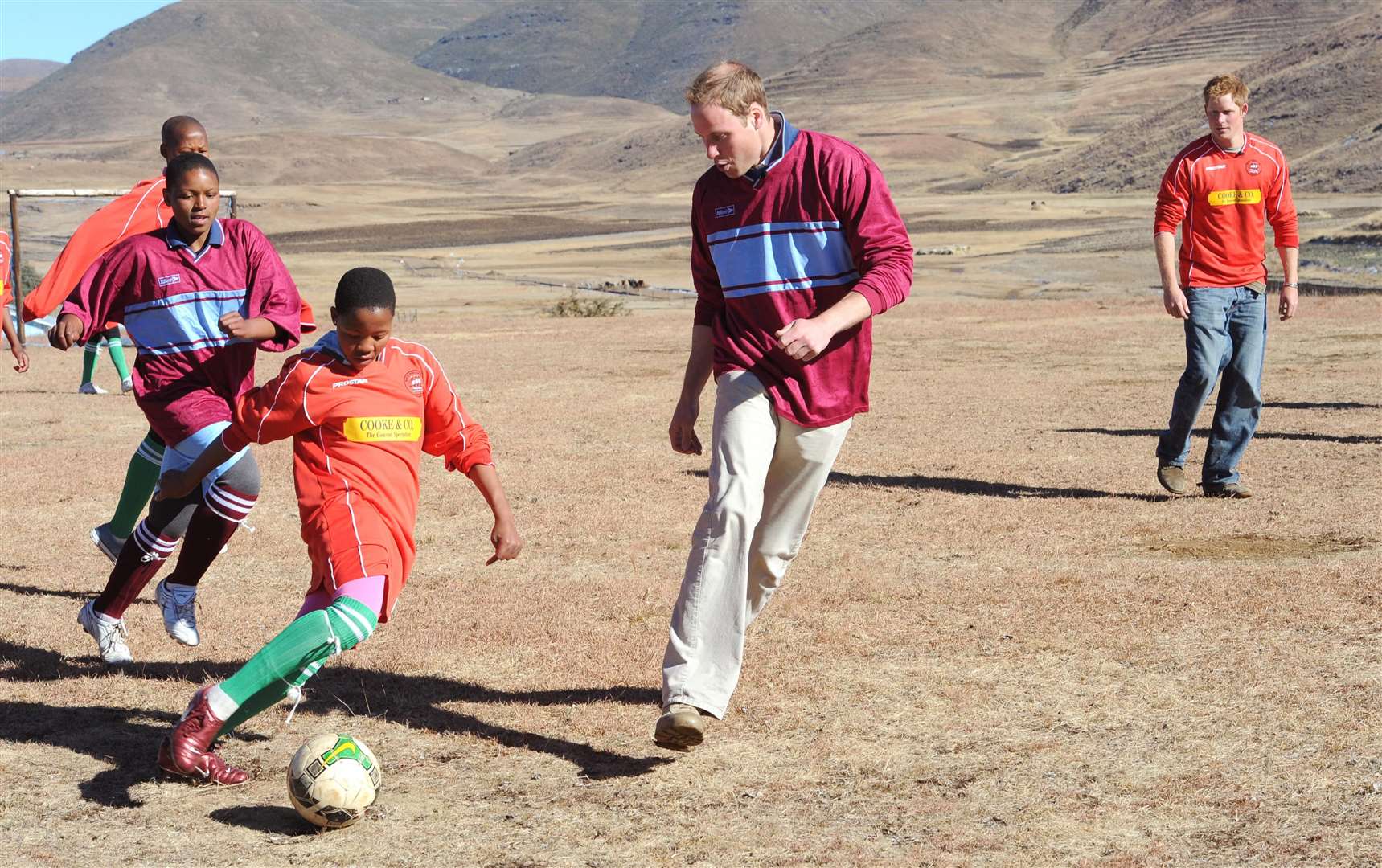 William and his brother Harry play football with orphaned children during a visit to the Semongkong Children’s Centre in Lesotho in 2010 (PA)