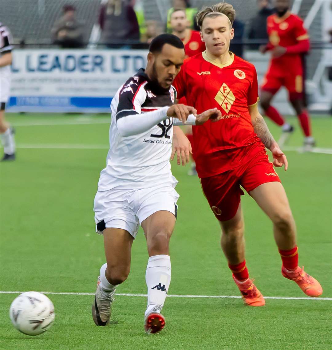 Whitstable’s Fin Cotton closes down Faversham’s Tariq Ossai in Saturday’s seven-goal thriller. Picture: Les Biggs