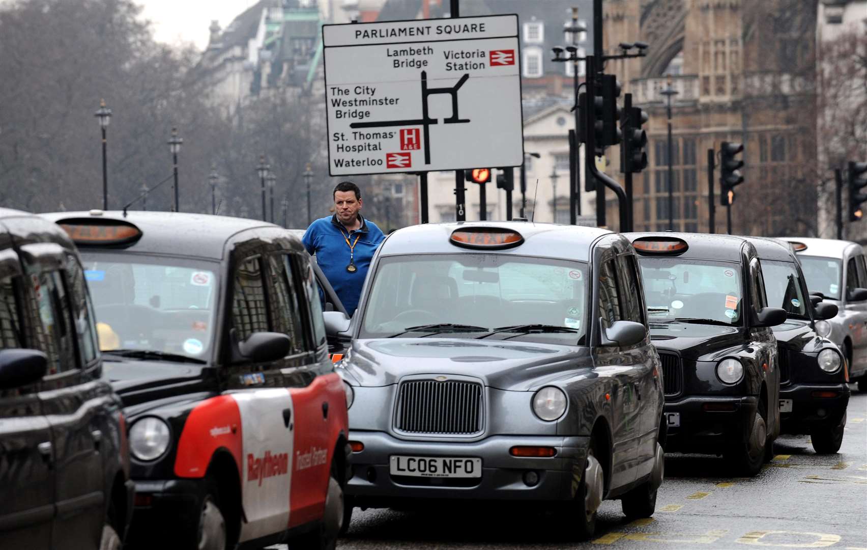 Taxi drivers line the street in Whitehall, London (Anthony Devlin/PA)