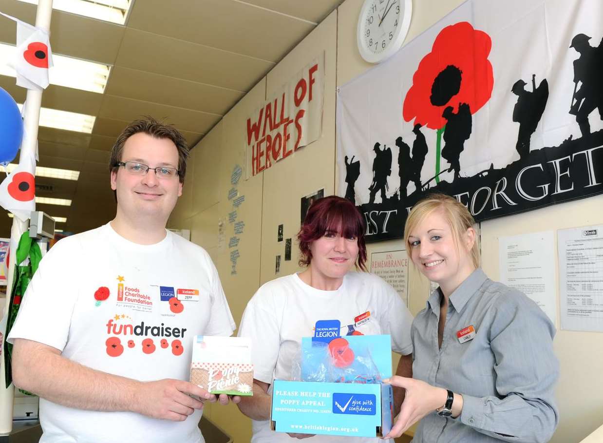 Jeff Hadaway, manager, with Natalie Wilkins and Carly Rowlingson at Iceland's wall of heroes