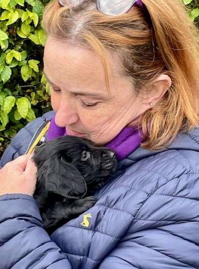 A new owner with her spaniel pup from the Lord Whisky Animal Sanctuary