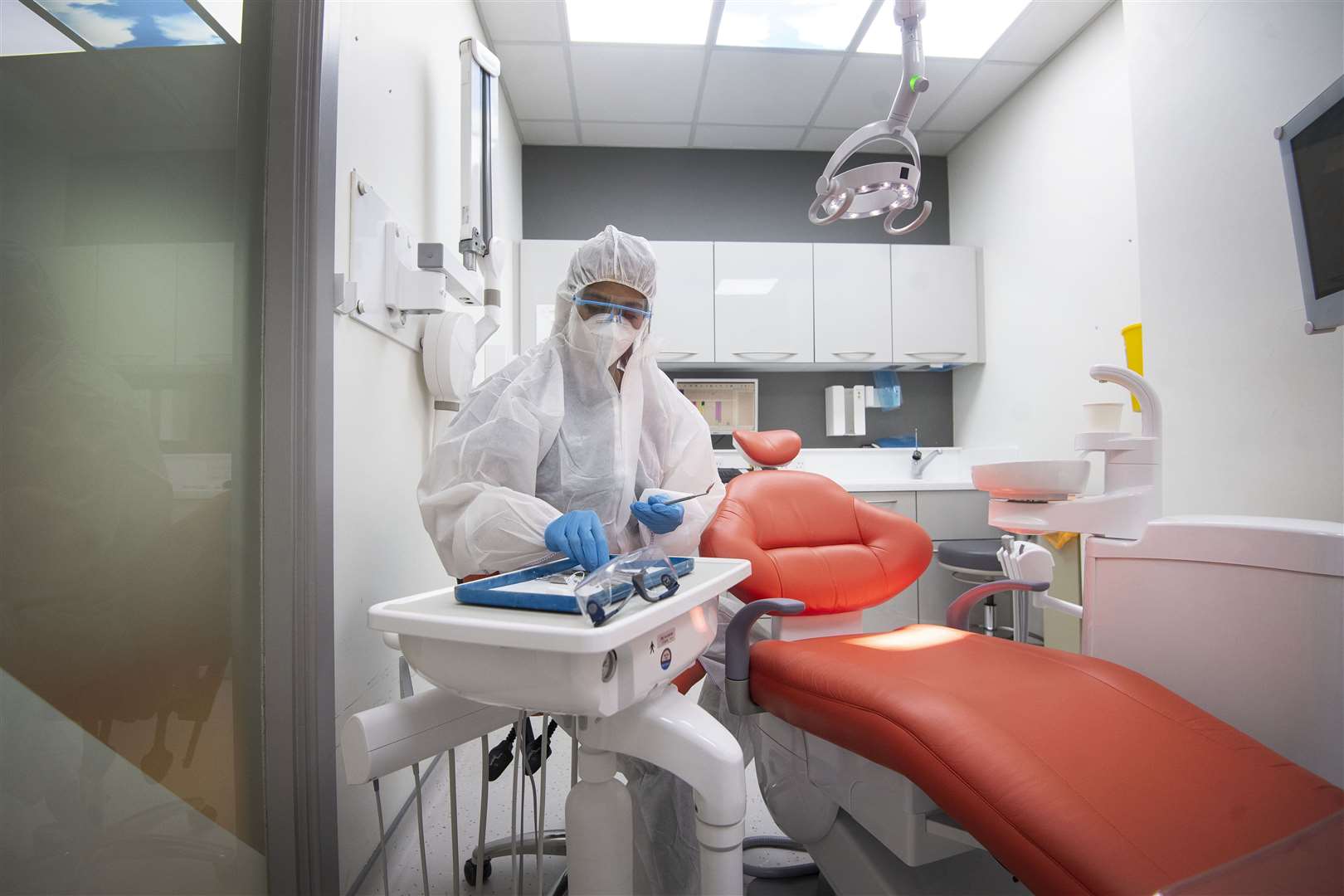 A dentist prepares for an aerosol-generating procedure wearing full PPE (Victoria Jones/PA)