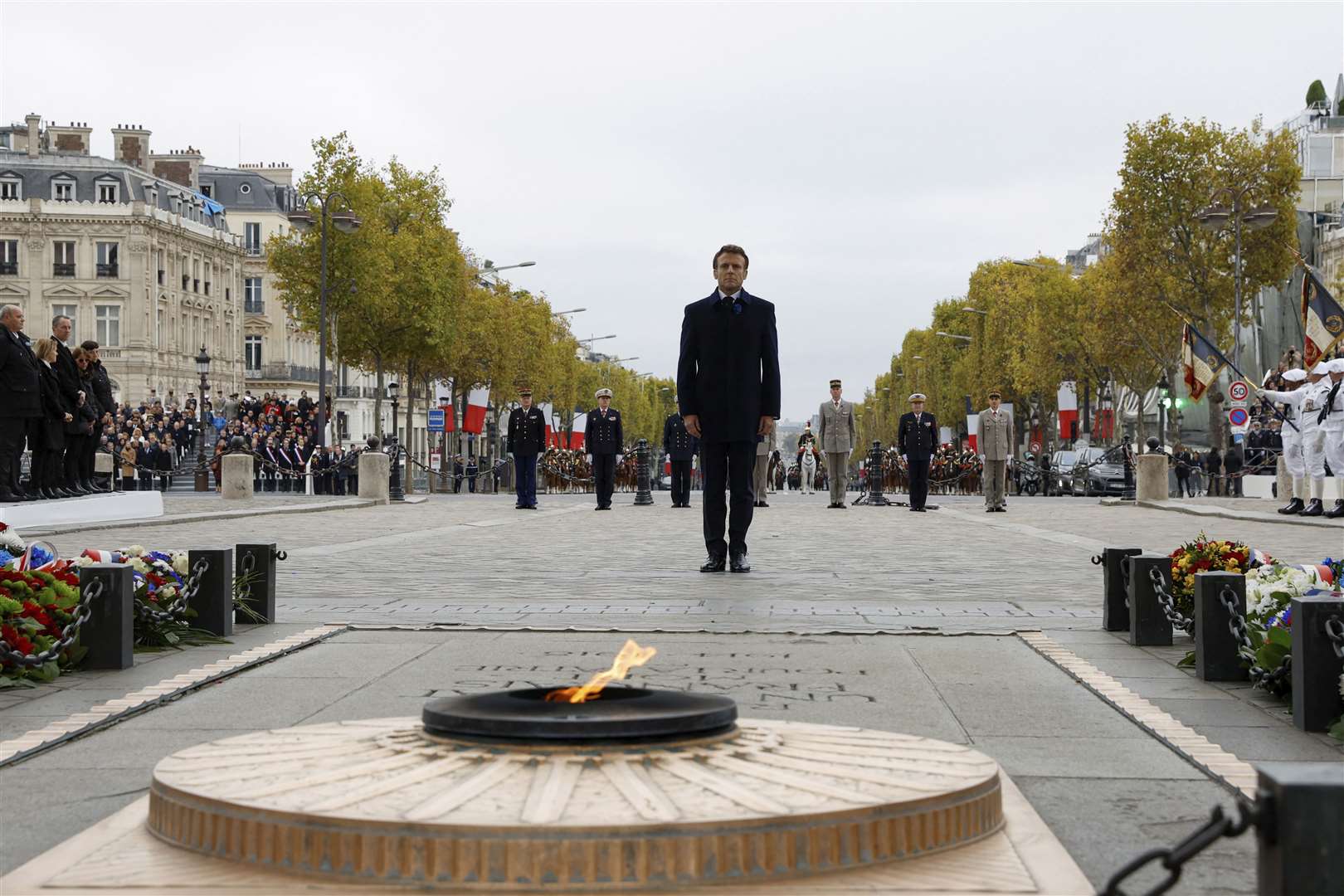 French president Emmanuel Macron stands at the Tomb of the Unknown Soldier during a ceremony at the Arc de Triomphe (Gonzalo Fuentes/Pool via AP)