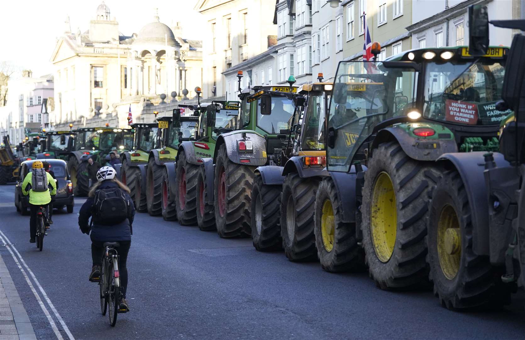 Tractors are lined up as farmers take part in a protest over the changes to inheritance tax (IHT) rules outside the Oxford Farming Conference (Andrew Matthews/PA)