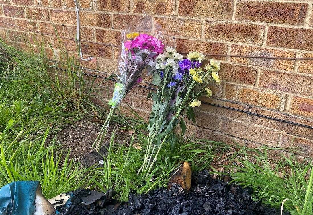 Floral tributes have been left at the scene for the unnamed victim following a bungalow fire in Sharon Crescent, Walderslade