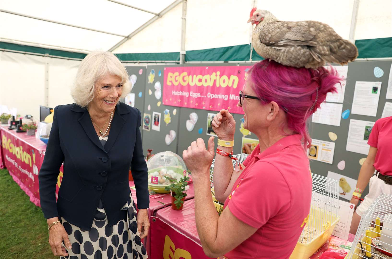 The Duchess of Cornwall meets Deb Howe, who has a chicken on her head (Chris Jackson/PA)