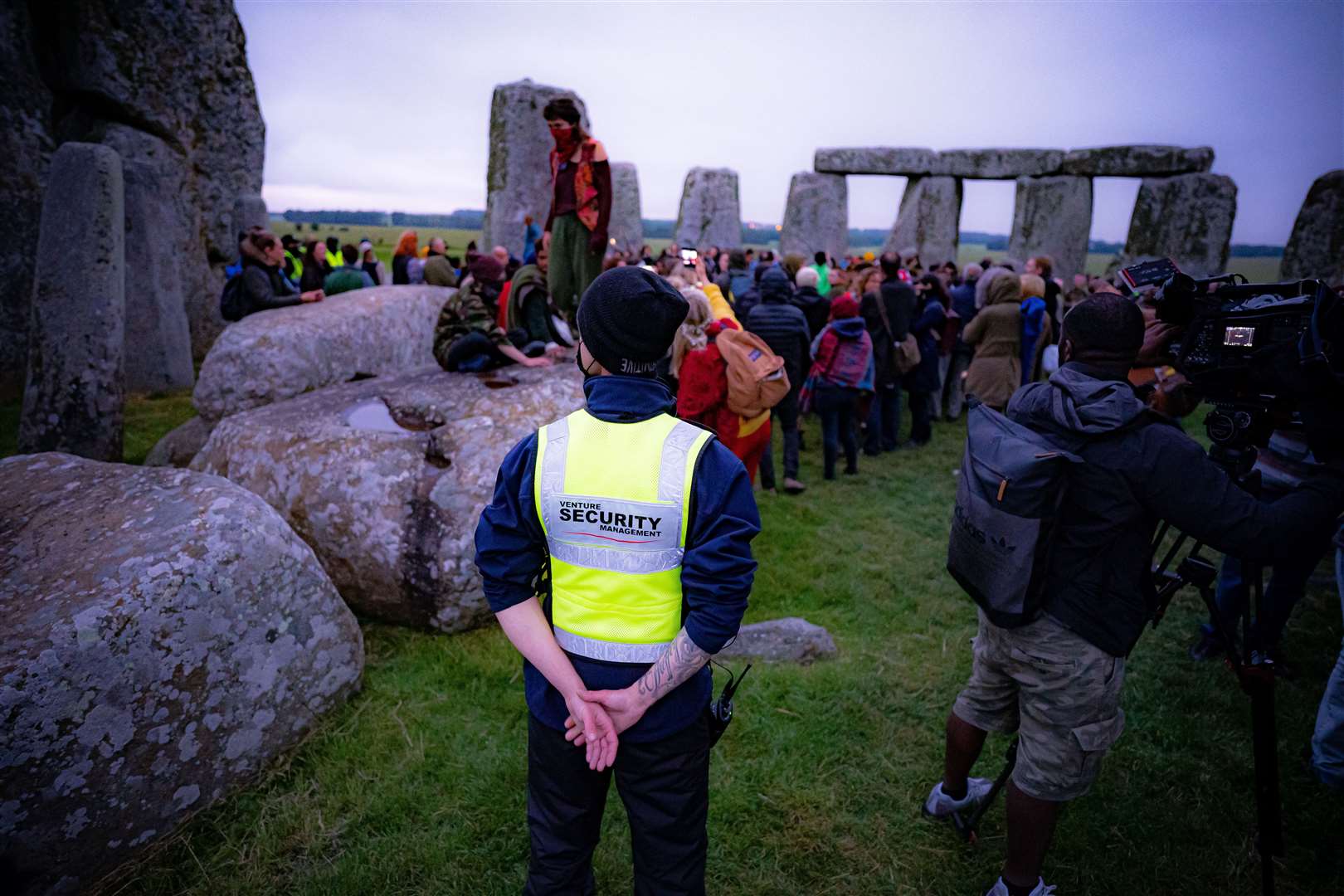 Security guards watch the crowds celebrate (Ben Birchall/PA)