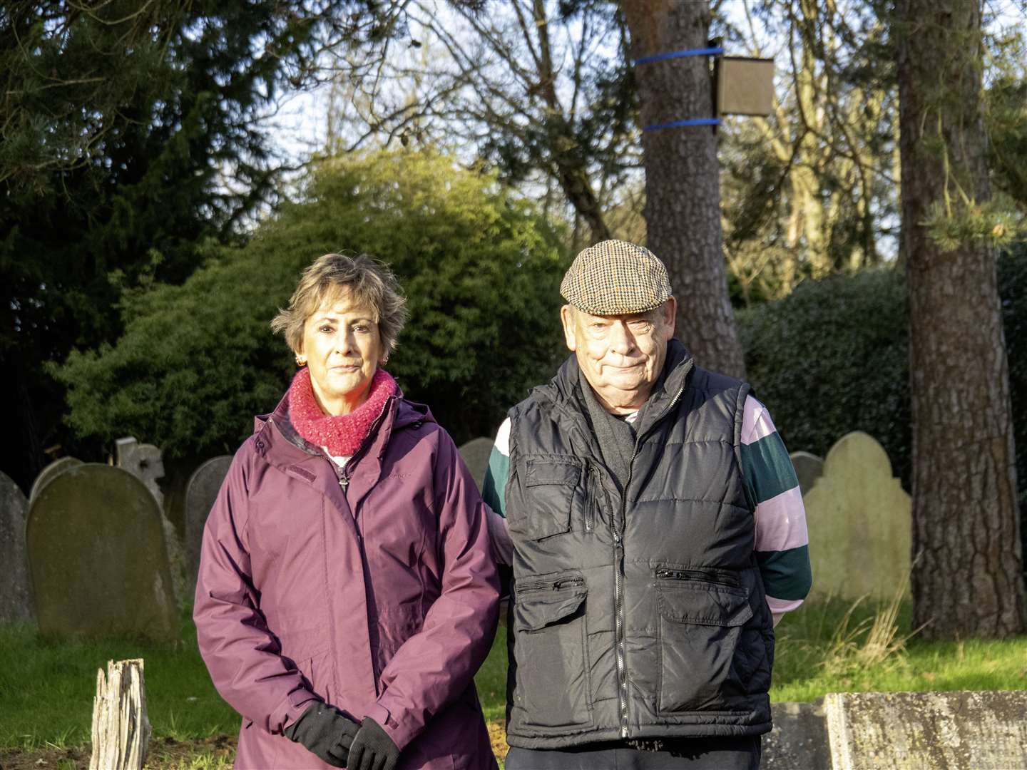 Chris Whitfield (right) and his wife Diane (left) standing in a cemetery that could soon be surrounded by pylons (Chris Whitfield/PA)