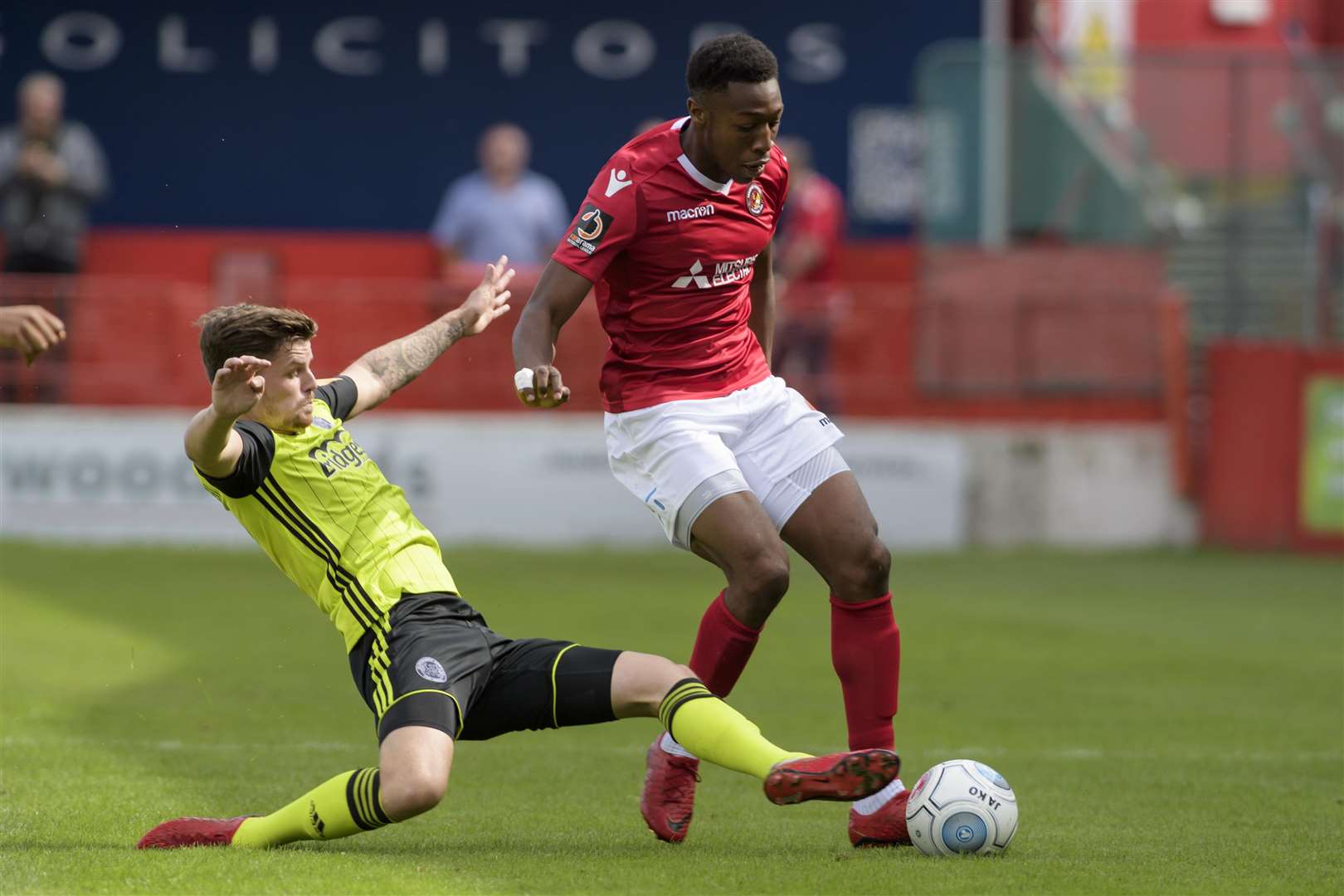 Eboe Adams battles forward under pressure against Aldershot Town