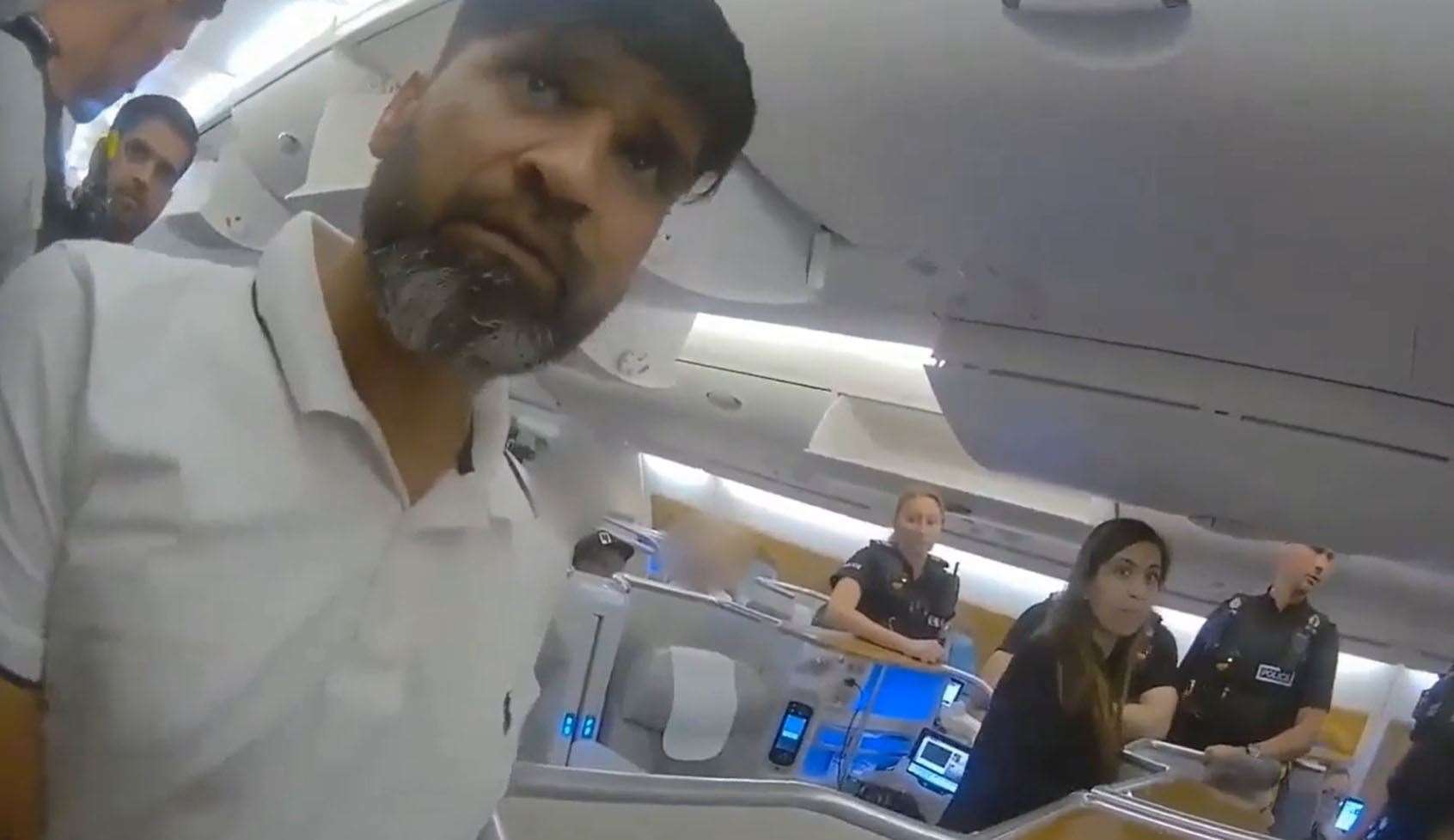 Screen grab from body cam footage of the moment police officers boarded a plane and detained Urfan Sharif and Beinash Batool (Surrey Police/PA)