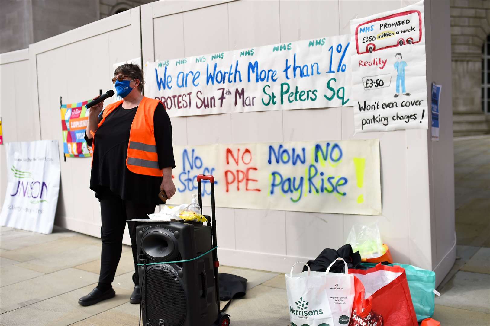 People protesting in St Peter’s Square in Manchester, over the proposed 1% pay rise for NHS workers from the Government (Jacob King/PA)