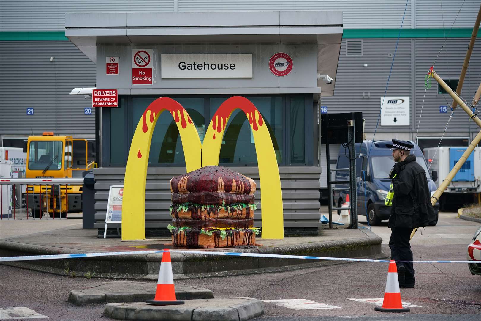 Police officer at a cordon around Animal Rebellion protesters outside a McDonalds distribution site in Hemel Hempstead (Yui Mok/PA)