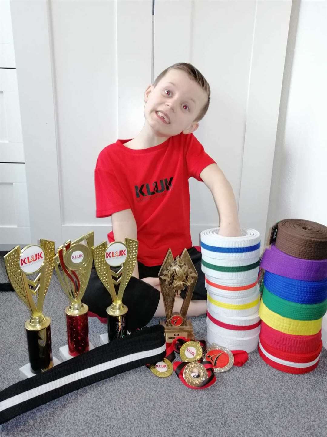 Eddy Cook with his belts and medals.