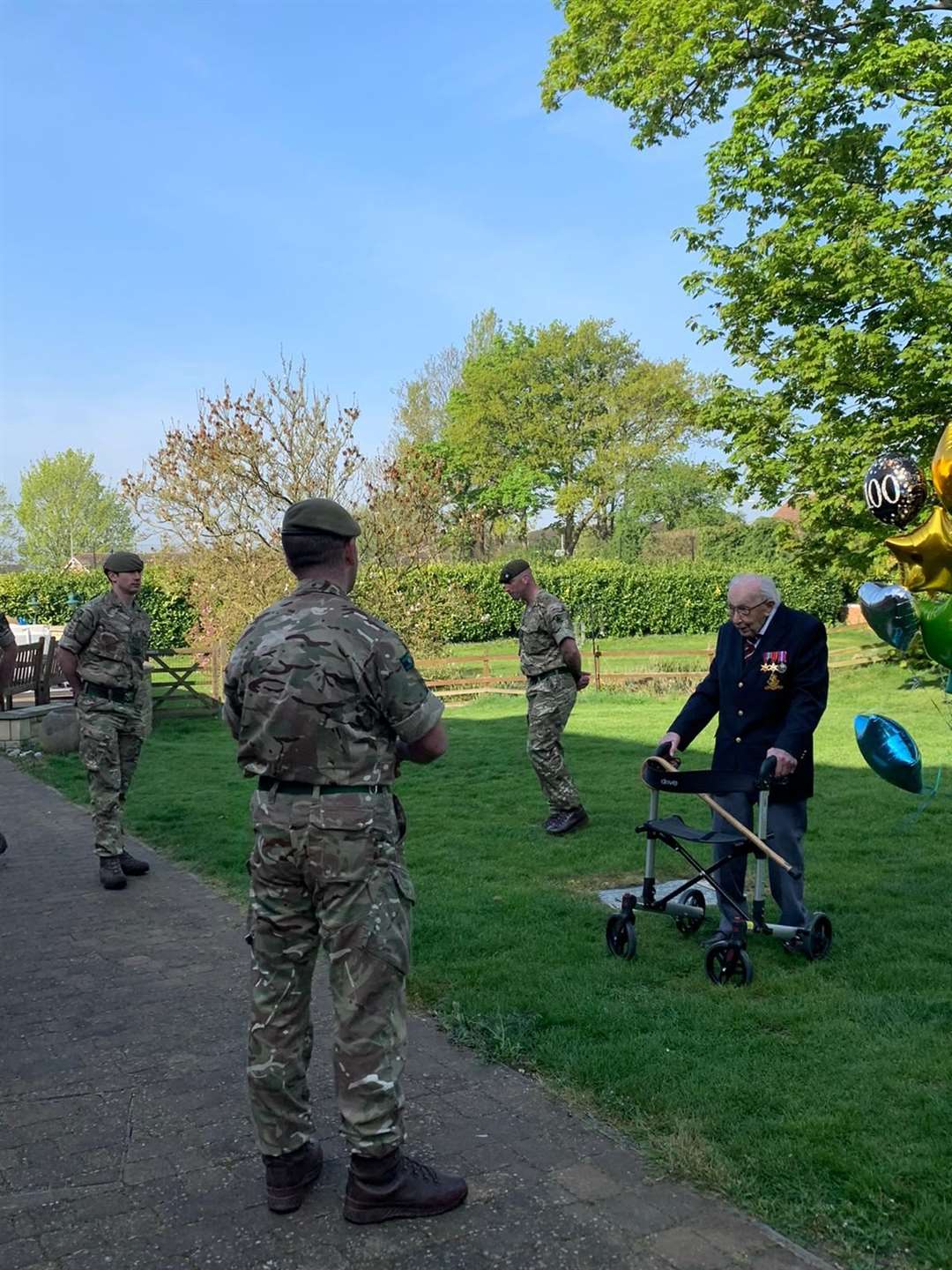 Captain Tom Moore (right), completes the 100th lap of his garden (Frances Haycock/MOD/Crown Copyright/PA)