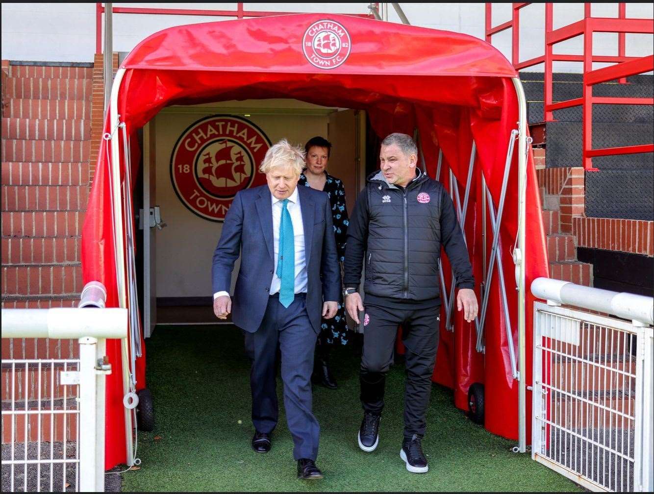 Chatham Town manager/chairman Kevin Hake shows prime minister Boris Johnson what his club have to offer Picture: CTFC