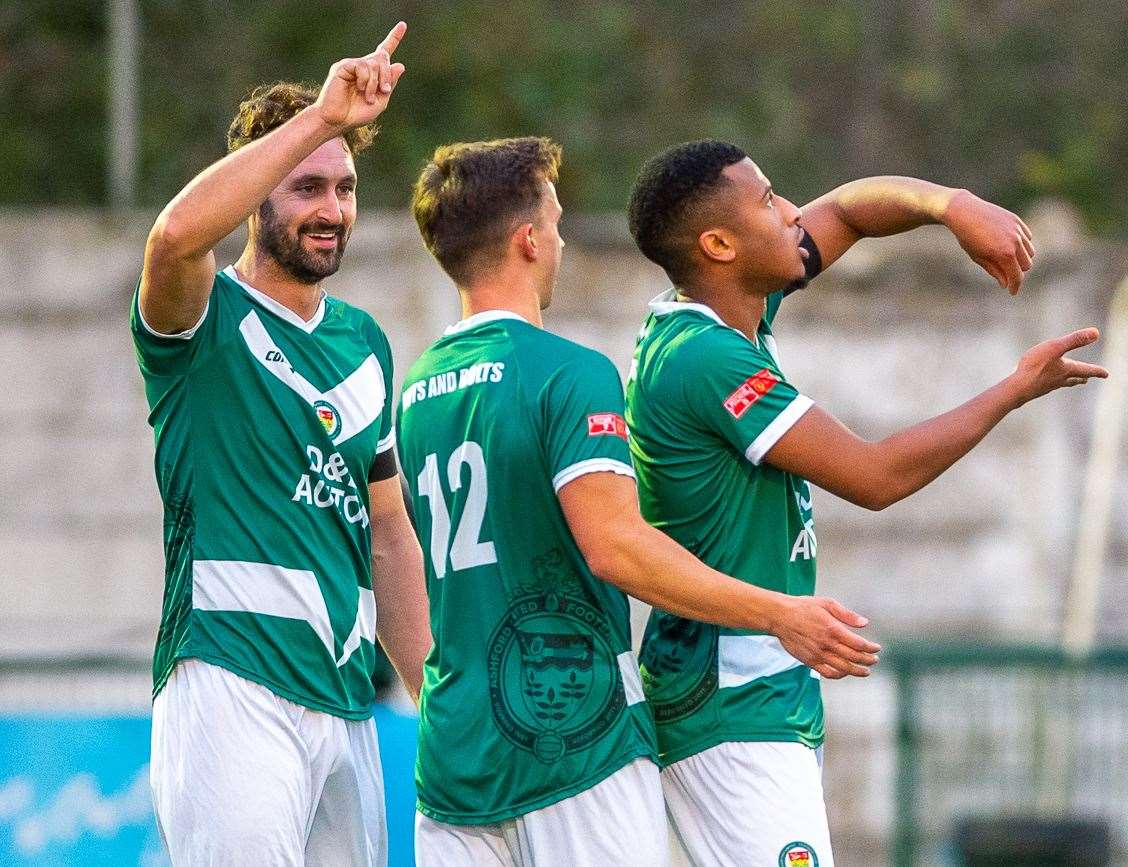 Ashford defender Mamadou Diallo celebrates making it 3-0 against Hythe with Johan ter Horst and Jay May Picture: Ian Scammell