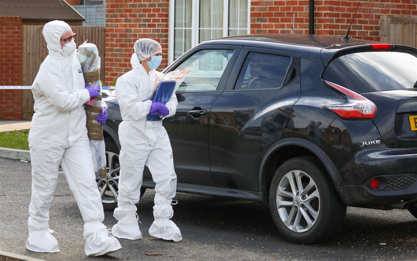 Crime scene investigators remove items including a laptop and what is thought to be the murder weapon from Wheeler's home in Sunshine Corner Avenue, Aylesham. Picture: UKNIP